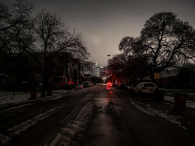 Buildings with power are lit in the distance from an area without power in Austin, Texas, on February 17, 2021.