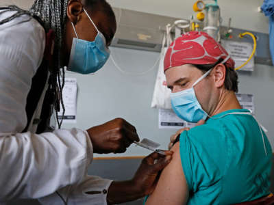 A healthcare worker receives a dose of the Johnson & Johnson vaccine against the COVID-19 coronavirus as South Africa proceeds with its inoculation campaign at the Steve Biko Academic Hospital in Pretoria on February 17, 2021.