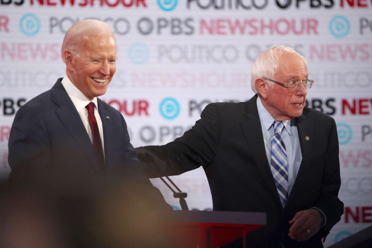 Sen. Bernie Sanders and former Vice President Joe Biden react during the Democratic presidential primary debate at Loyola Marymount University on December 19, 2019, in Los Angeles, California.