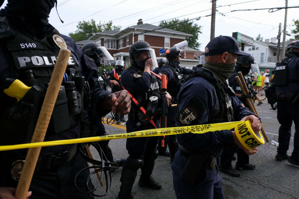 Louisville Metro Police Department put up police tape in Louisville, Kentucky, as protestors march on September 23, 2020.