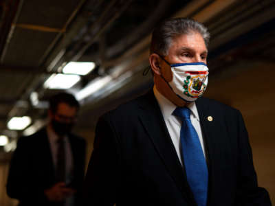 Sen. Joe Manchin walks on the senate side of the Capitol Building on March 5, 2021, in Washington, D.C.