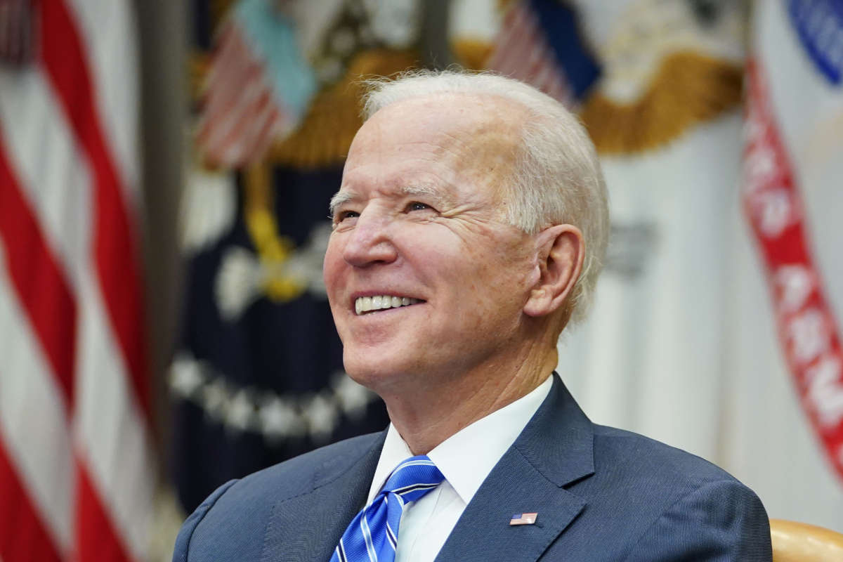 President Joe Biden smiles as he speaks during a virtual call in the Roosevelt Room of the White House in Washington, D.C. on March 4, 2021.