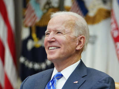 President Joe Biden smiles as he speaks during a virtual call in the Roosevelt Room of the White House in Washington, D.C. on March 4, 2021.