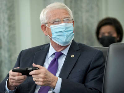 Sen. Roger Wicker looks at his phone prior to a committee hearing on October 28, 2020, on Capitol Hill in Washington, D.C.