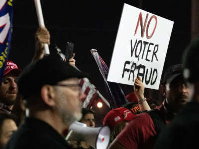 A "no voter fraud" sign is displayed by a protester at the Maricopa County Elections Department office on November 4, 2020, in Phoenix, Arizona.