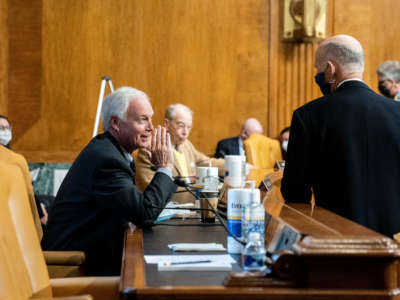 Sen. Ron Johnson (left) speaks to Sen. Rick Scott prior to a confirmation hearing before the Senate Budget Committee on February 10, 2021, at the U.S. Capitol in Washington, D.C.