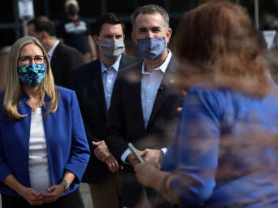 Virginia Governor Ralph Northam and Rep. Jennifer Wexton greet voters outside an early voting location at Fairfax County Government Center on October 19, 2020, in Fairfax, Virginia.