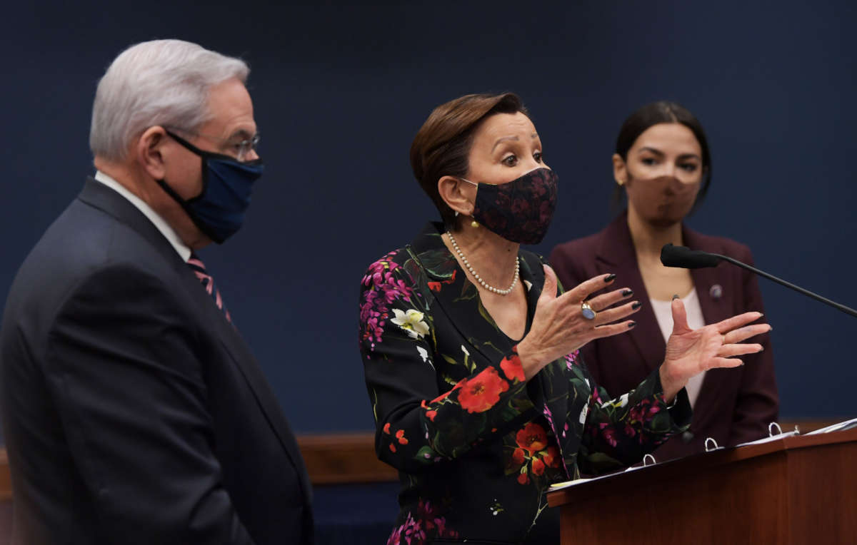 Rep. Nydia Velzquez (center), alongside Rep. Alexandria Ocasio Cortez and Sen. Bob Menendez, speaks during a press conference about bicameral introduction of the Puerto Rico Self-Determination Act of 2021, on March 18, 2021, at Capitol Hill in Washington D.C.