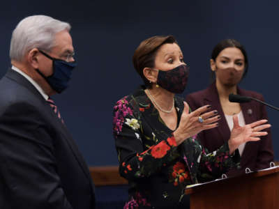 Rep. Nydia Velzquez (center), alongside Rep. Alexandria Ocasio Cortez and Sen. Bob Menendez, speaks during a press conference about bicameral introduction of the Puerto Rico Self-Determination Act of 2021, on March 18, 2021, at Capitol Hill in Washington D.C.