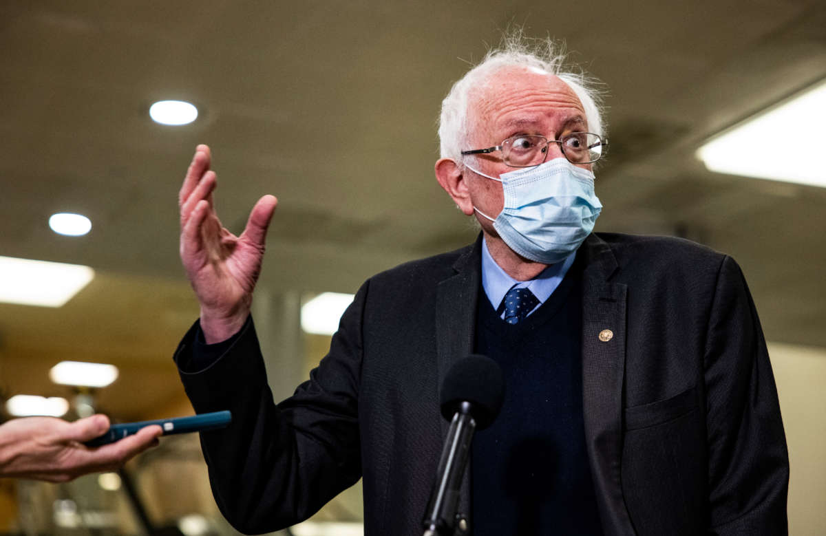 Sen. Bernie Sanders talks to reporters in the Senate subway at the U.S. Capitol on February 12, 2021, in Washington, D.C.