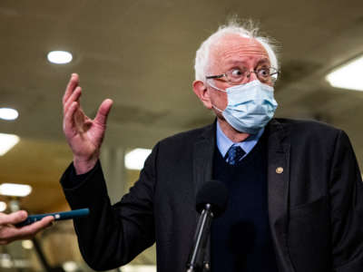 Sen. Bernie Sanders talks to reporters in the Senate subway at the U.S. Capitol on February 12, 2021, in Washington, D.C.