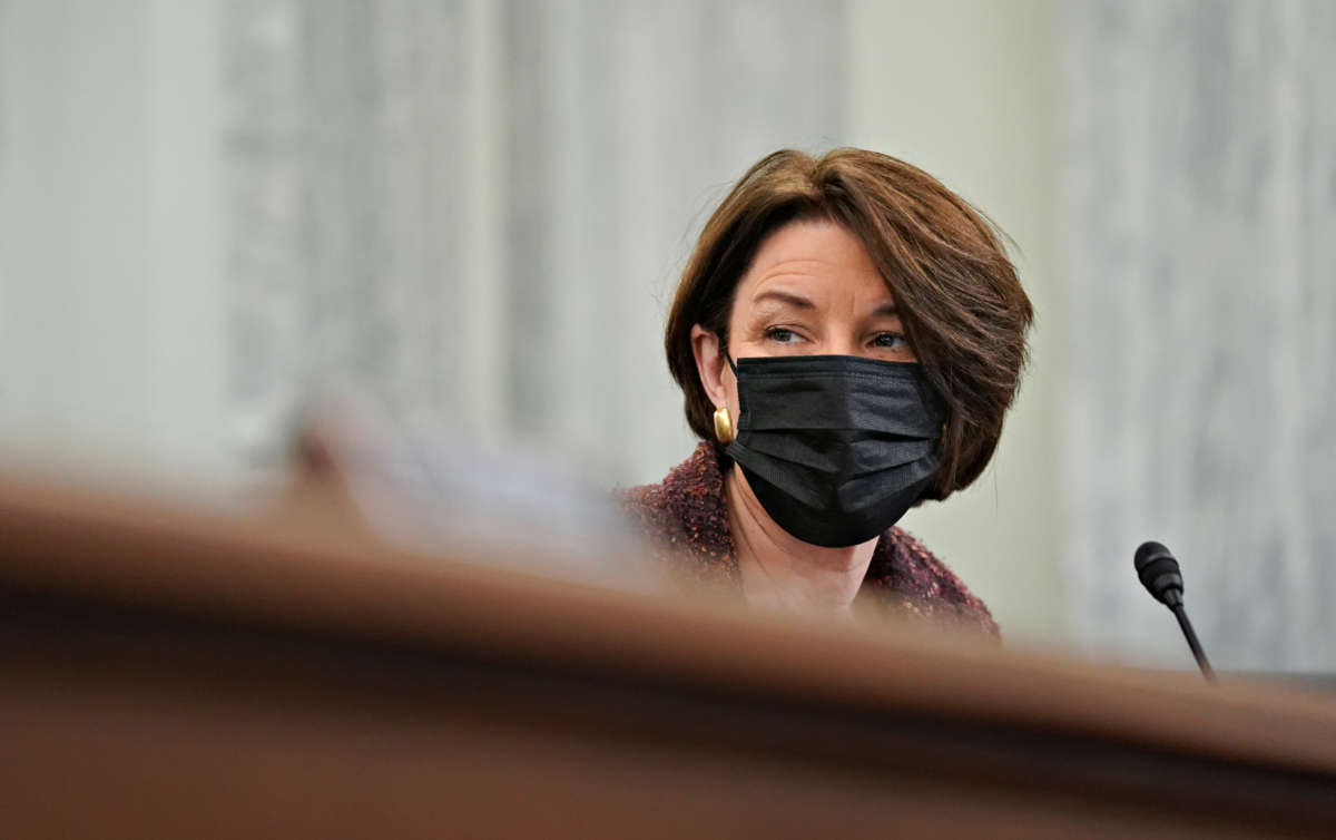 Sen. Amy Klobuchar wears a protective mask during a Senate Commerce, Science and Transportation Committee confirmation hearing on January 21, 2021, in Washington, D.C.