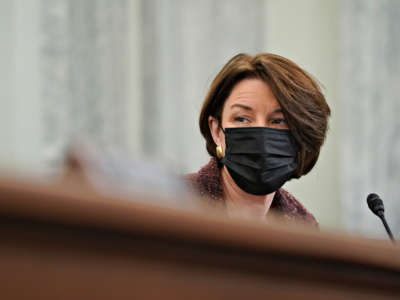 Sen. Amy Klobuchar wears a protective mask during a Senate Commerce, Science and Transportation Committee confirmation hearing on January 21, 2021, in Washington, D.C.