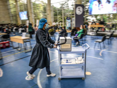 A nurse moves doses of the CoronaVac vaccine against the COVID-19 disease in Bogota on March 26, 2021.