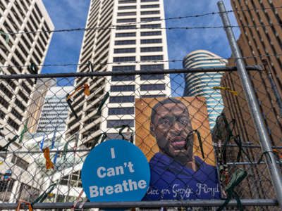 A poster with George Floyd's picture and a sign reads that "I Can't Breathe" hang from a security fence outside the Hennepin County Government Center on March 30, 2021, in Minneapolis, Minnesota.