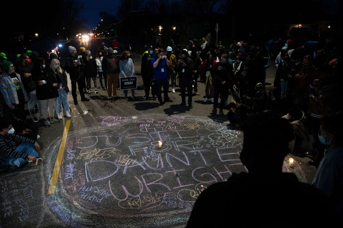 Protesters create a chalk circle that reads "Justice for Daunte Wright" in the street on April 11, 2021, in Brooklyn Center, Minnesota.