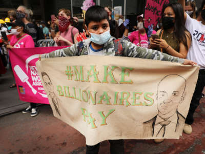 People participate in a "March on Billionaires" event on July 17, 2020, in New York City.