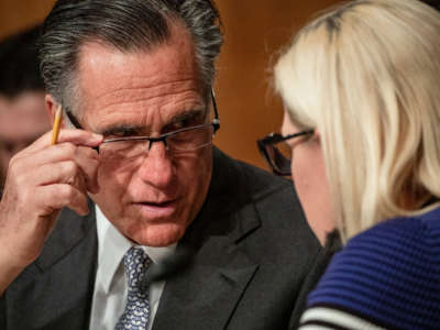 Sens. Mitt Romney and Kyrsten Sinema speak to each other during a Senate Homeland Security Committee hearing on March 5, 2020, in Washington, D.C.