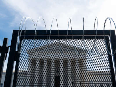 Razor wire-topped riot fencing stands in front of the U.S. Supreme Court on March 15, 2021.