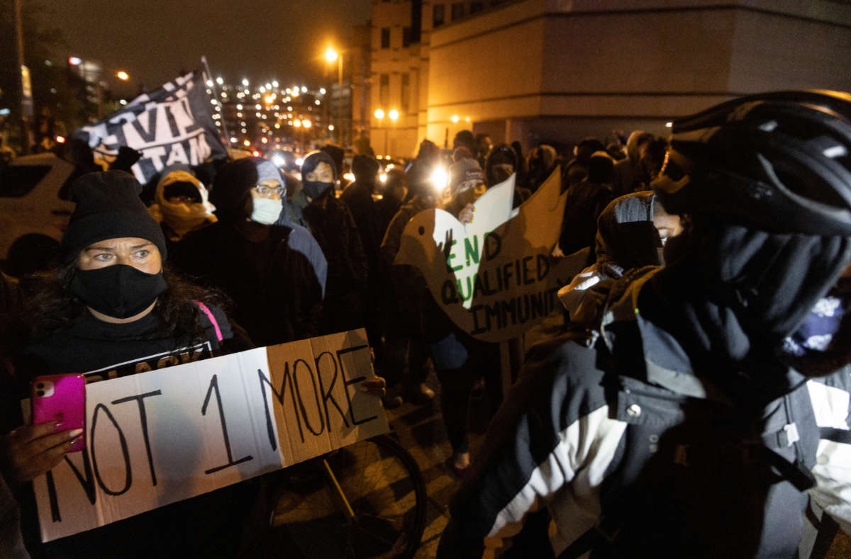 Black Lives Matter activists form a line across from a line of police to protest the police shooting of Ma'Khia Bryant on April 20, 2021, in Columbus, Ohio.