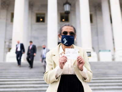 Del. Eleanor Holmes Norton holds a card on the House steps with the final vote count after the House passed HR 51 with a 216-208 vote at the Capitol on Thursday, April 22, 2021. The legislation would create the new state of Washington, Douglass Commonwealth, with one representative and two senators.