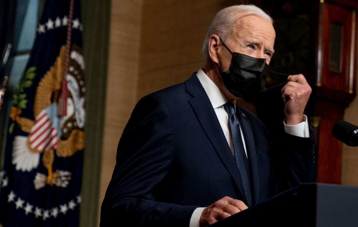 President Joe Biden removes his mask to speak from the Treaty Room in the White House on April 14, 2021, in Washington, D.C.