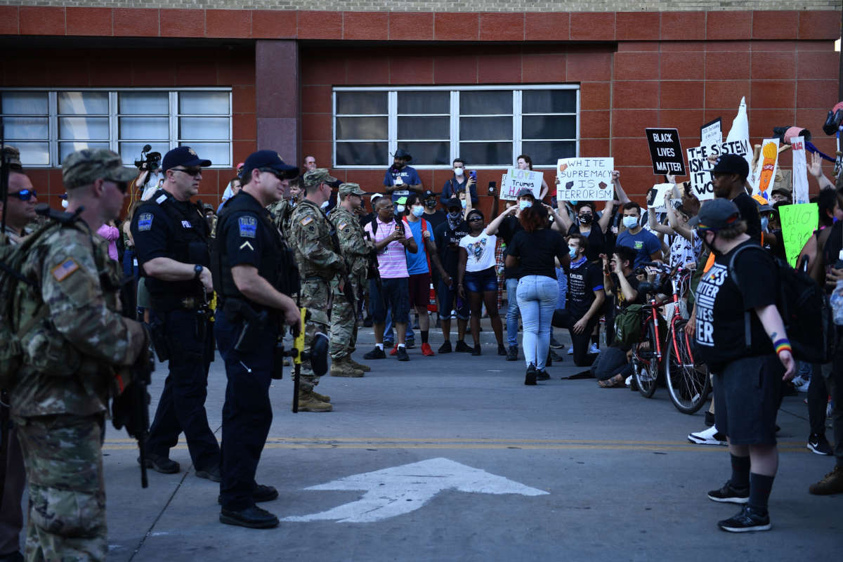 National Guard and police officers stand before anti-Trump protestors in Tulsa, Oklahoma, on June 20, 2020.