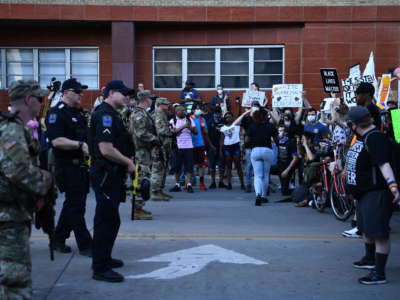 National Guard and police officers stand before anti-Trump protestors in Tulsa, Oklahoma, on June 20, 2020.