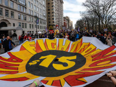 "Fight For $15" protesters, including workers and labor unions, march to raise the minimum wage to $15/hour, at Colombus Square in New York on April 15, 2015.