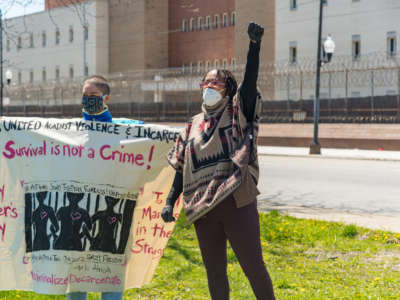 Colette Payne (right) speaks at the annual Mother's Day vigil, organized by Moms United Against Violence and Incarceration, outside Cook County Jail in Chicago. Payne and other organizers at the Women's Justice Institute released a report yesterday detailing the impact of incarceration on women and explaining how to dramatically reduced the Illinois women's prison population.