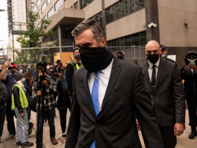 Former Minneapolis Police officers Thomas Lane, center, and J. Alexander Keung, right, leave the Hennepin County Family Justice Center after a pre-trial hearing on September 11, 2020, in Minneapolis, Minnesota.