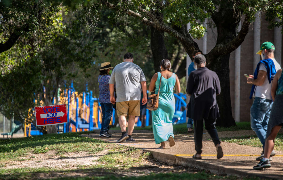 Voters approach the door at a polling location on October 13, 2020, in Austin, Texas.
