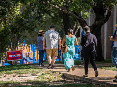 Voters approach the door at a polling location on October 13, 2020, in Austin, Texas.