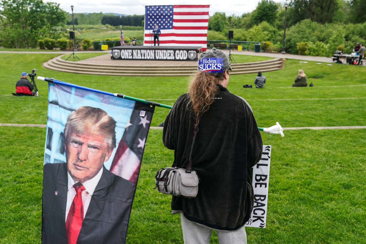 Paul Roblyer of Portland holds a flag with the face of former President Donald Trump during a 2nd Amendment rally on May 1, 2021, in Salem, Oregon.