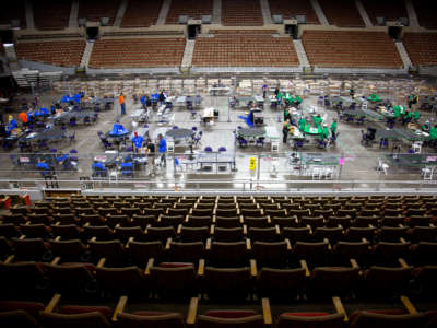 Contractors working for Cyber Ninjas, who was hired by the Arizona State Senate, examine and recount ballots from the 2020 general election at Veterans Memorial Coliseum on May 1, 2021, in Phoenix, Arizona.