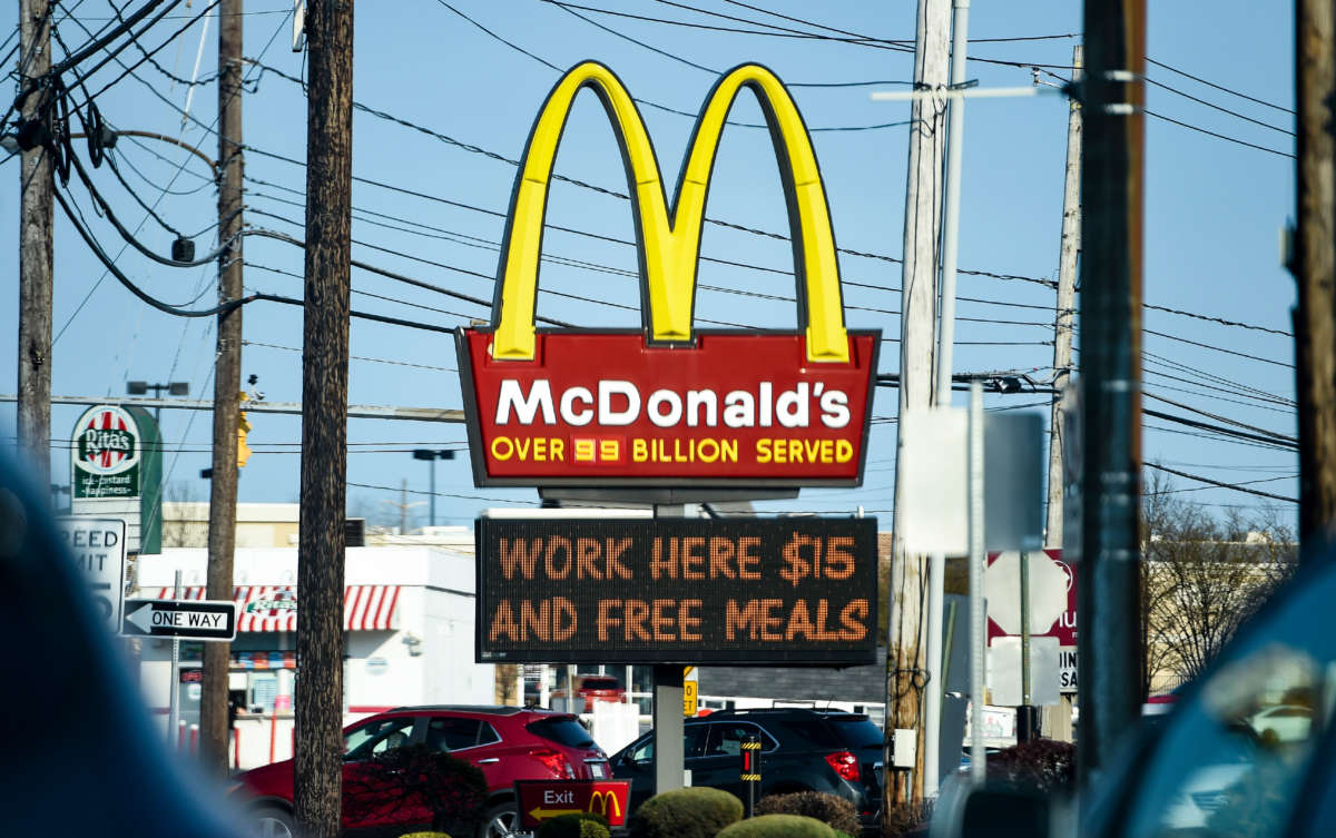The sign at the McDonald's restaurant on Penn Ave in Sinking Spring, Pennsylvania, on April 8, 2021, with a message on a board below it that reads "Work Here $15 And Free Meals."