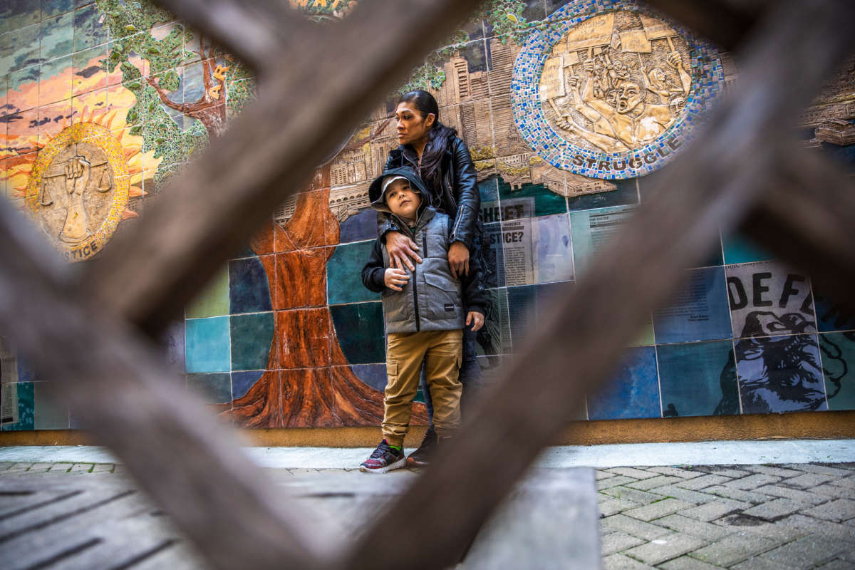Juthaporn Chaloeicheep, 44, and son Douglas Jones, 5, stand for a portrait in the courtyard of Arnett Watson Apartments, a permanent supportive housing community where they reside in the Tenderloin district of San Francisco, California, on March 16, 2021.
