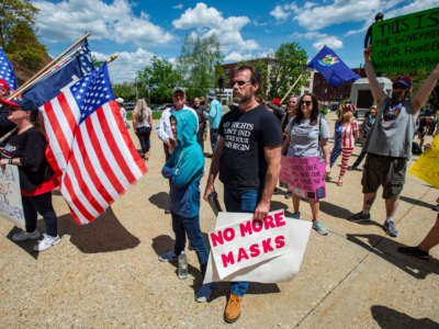 Rally goers protest vaccines and the current administration during the "World Wide Rally for Freedom," an anti-mask and anti-vaccine rally, at the statehouse in Concord, New Hampshire, May 15, 2021.