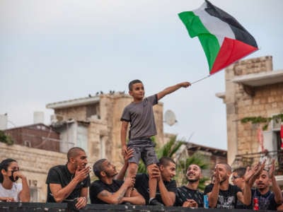 A boy waves a Palestinian flag during a demonstration