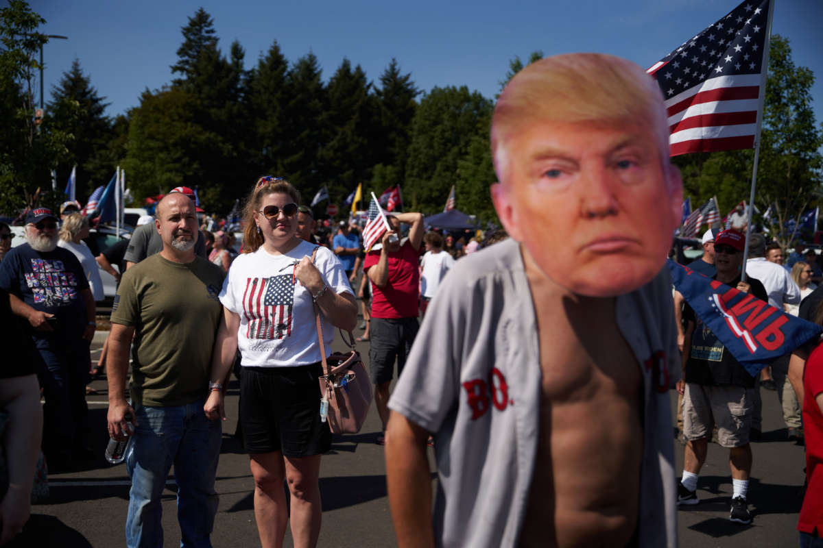 Trump supporters listen to a speaker during a rally and caravan in Oregon City, Oregon, on September 7, 2020.