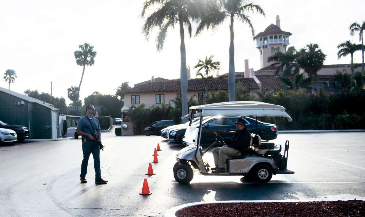 A member of the Secret Service stands guard as then-President Donald Trump departs Mar-a-Lago on March 25, 2018, in Palm Beach, Florida.