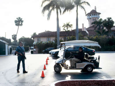 A member of the Secret Service stands guard as then-President Donald Trump departs Mar-a-Lago on March 25, 2018, in Palm Beach, Florida.