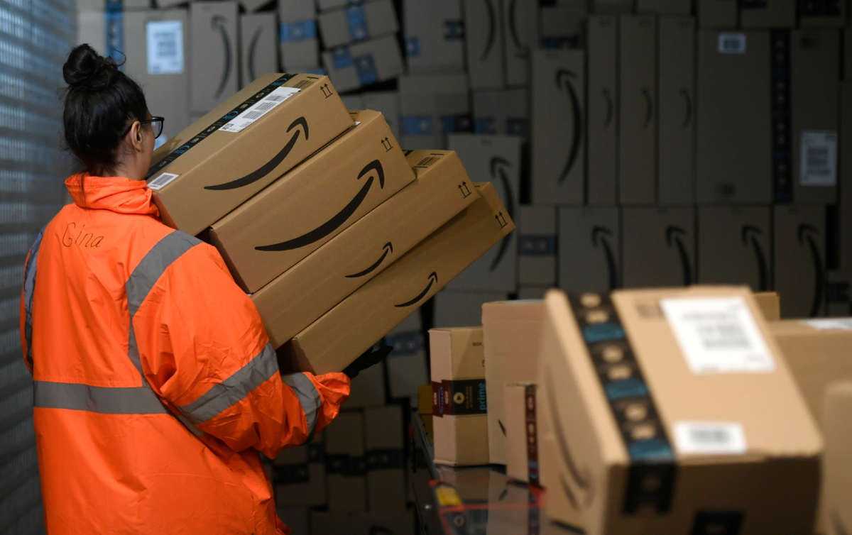 An employee places boxes at the distribution center of online retail giant Amazon in Moenchengladbach, Germany, on December 17, 2019.