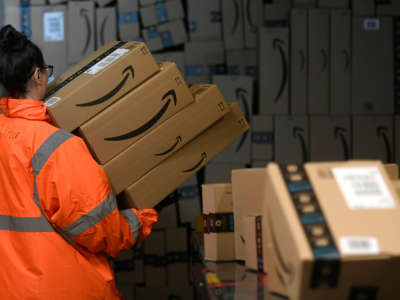 An employee places boxes at the distribution center of online retail giant Amazon in Moenchengladbach, Germany, on December 17, 2019.
