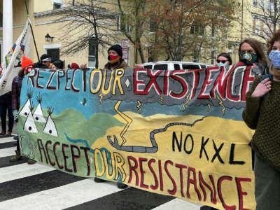 Activists display banners referring to the shutting down of existing oil pipelines in the northern U.S. at Black Lives Matter Plaza in Washington, D.C. on April 1, 2021.