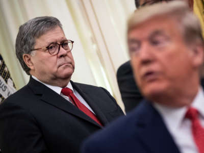 Attorney General William Barr and President Donald Trump attend a signing ceremony for an executive order in the Oval Office of the White House on November 26, 2019, in Washington, D.C.