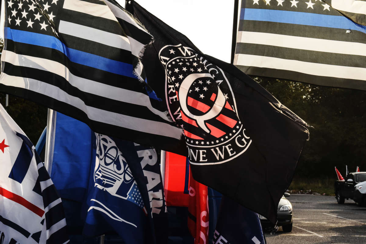 A flag for the QAnon conspiracy theory is flown with other right wing flags during a pro-Trump rally on October 11, 2020, in Ronkonkoma, New York.