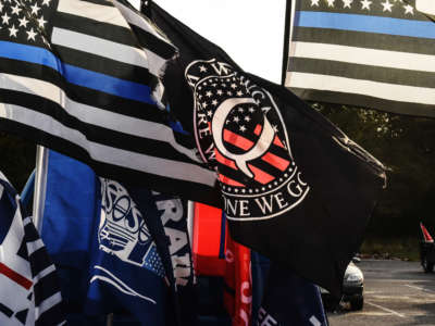 A flag for the QAnon conspiracy theory is flown with other right wing flags during a pro-Trump rally on October 11, 2020, in Ronkonkoma, New York.