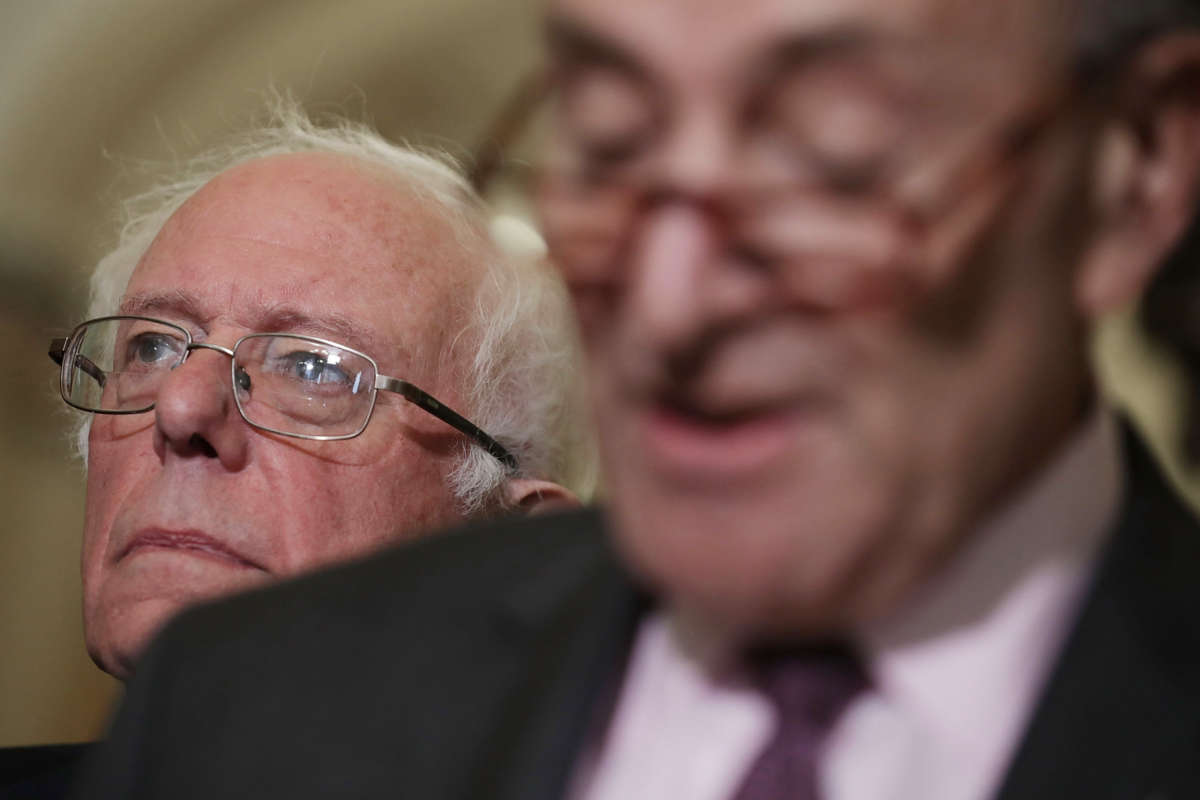 Senators Bernie Sanders and Charles Schumer speak to reporters at the U.S. Capitol on October 3, 2017, in Washington, D.C.