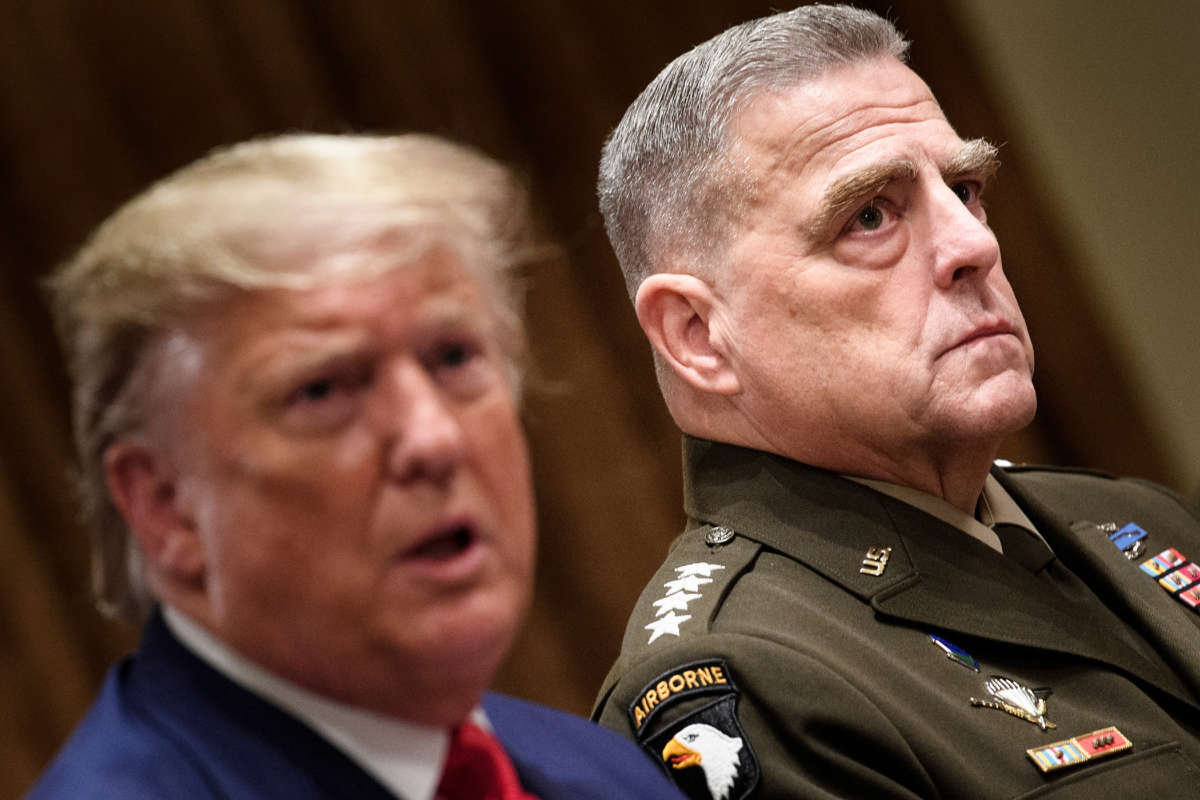 Chairman of the Joint Chiefs of Staff Army General Mark A. Milley, right, listens while President Donald Trump speaks before a meeting with senior military leaders in the Cabinet Room of the White House in Washington, D.C. on October 7, 2019.
